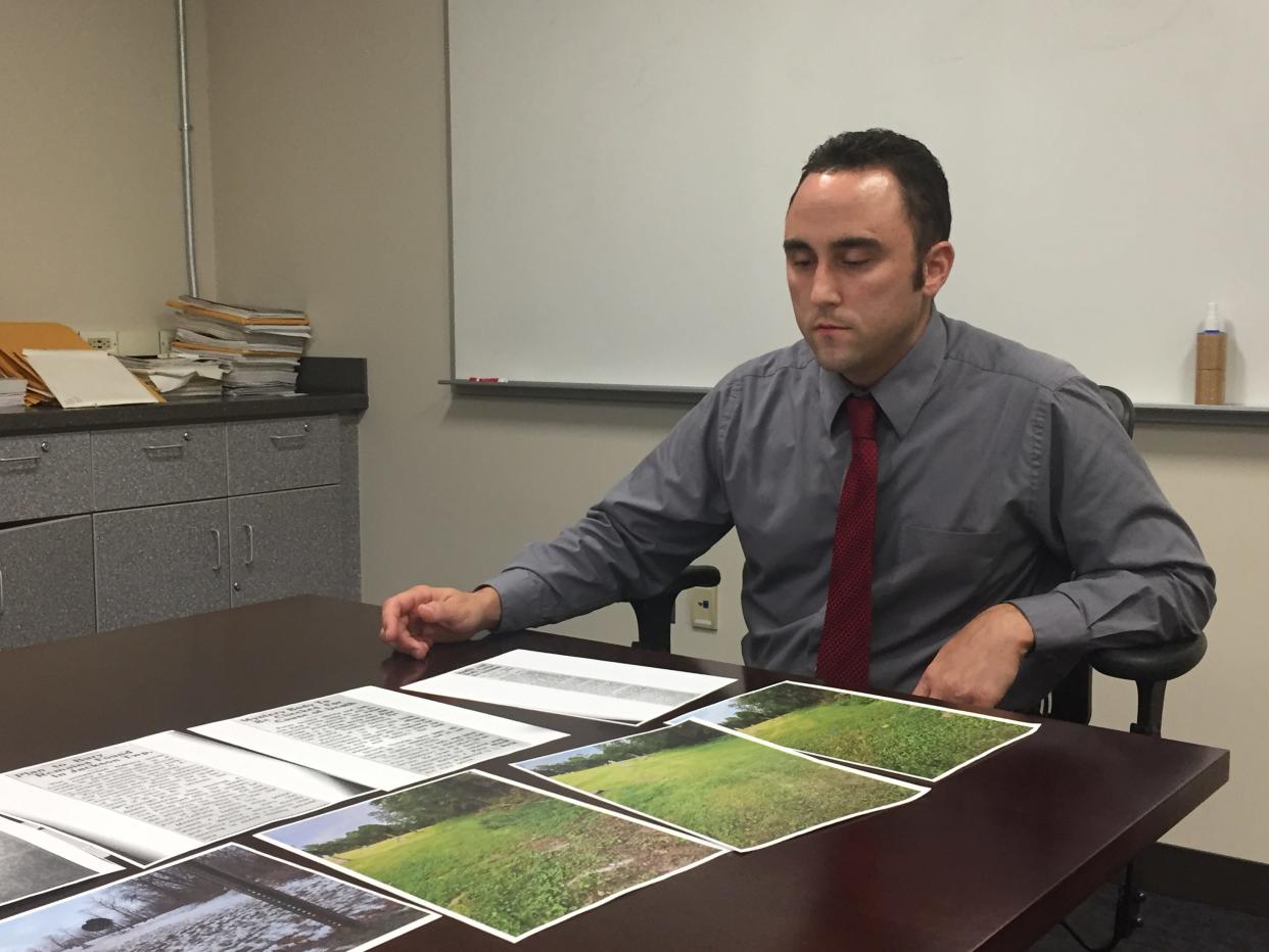 Shelby police Detective Adam Turner goes over paperwork in his investigation of missing Shelby woman Mary Jane Croft Vangilder. She was last seen in 1945.