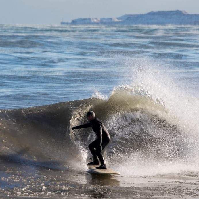 Dave Benjamin, co-founder of the Great Lakes Surf Rescue Project, takes on an icy wave