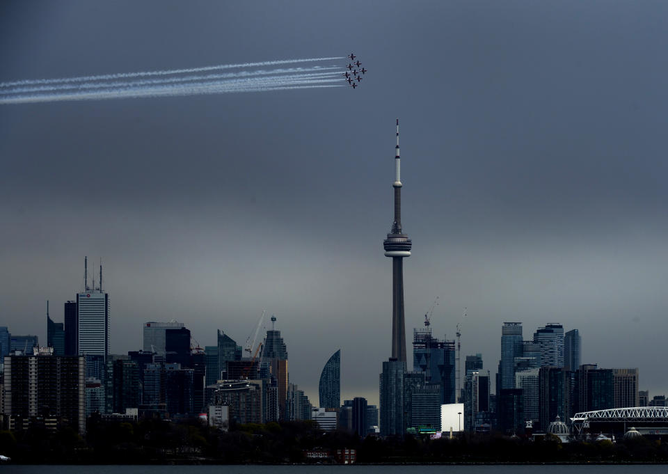 The Canadian Snowbirds circle the CN Tower as part of Operation Inspiration during the COVID-19 pandemic in Toronto on Sunday, May 10, 2020. (Nathan Denette/The Canadian Press via AP)