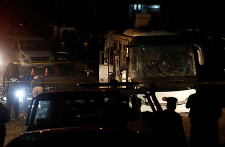 Police officers inspect a scene of a bus blast in Giza, Egypt, December 28, 2018. REUTERS/Amr Abdallah Dalsh