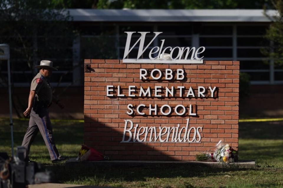 An officer walks outside of Robb Elementary School in Uvalde, Texas, on May 25, 2022. (Photo by ALLISON DINNER/AFP via Getty Images)