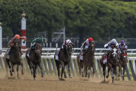 Tiz the Law (8), with jockey Manny Franco up, second from right, leads the pack down the home stretch during the152nd running of the Belmont Stakes horse race, Saturday, June 20, 2020, in Elmont, N.Y. Tiz the Law won the race. (AP Photo/Seth Wenig)