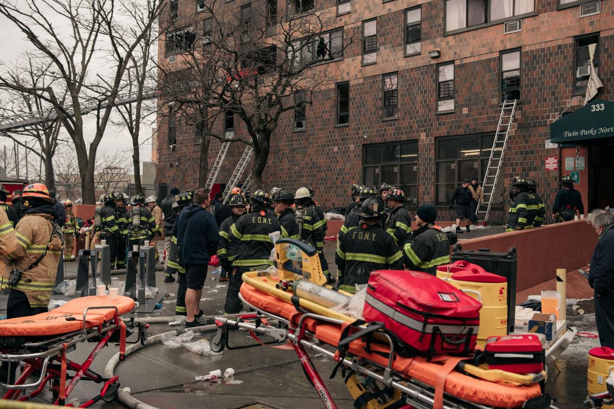 Emergency first responders remain at the scene of an intense fire at a 19-story residential building that erupted in the morning on Jan. 9, 2022, in the Bronx borough of New York City.