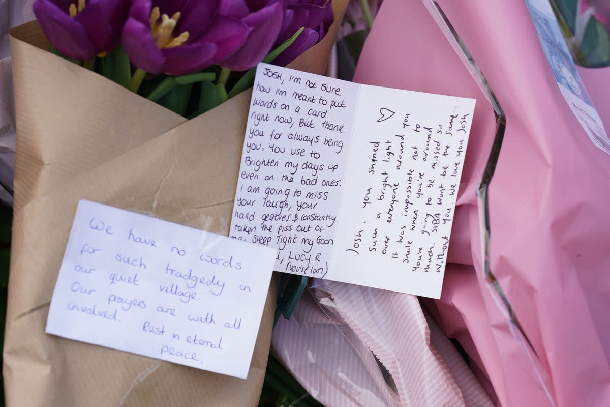 Notes left in tribute to the victims at the scene (PA)