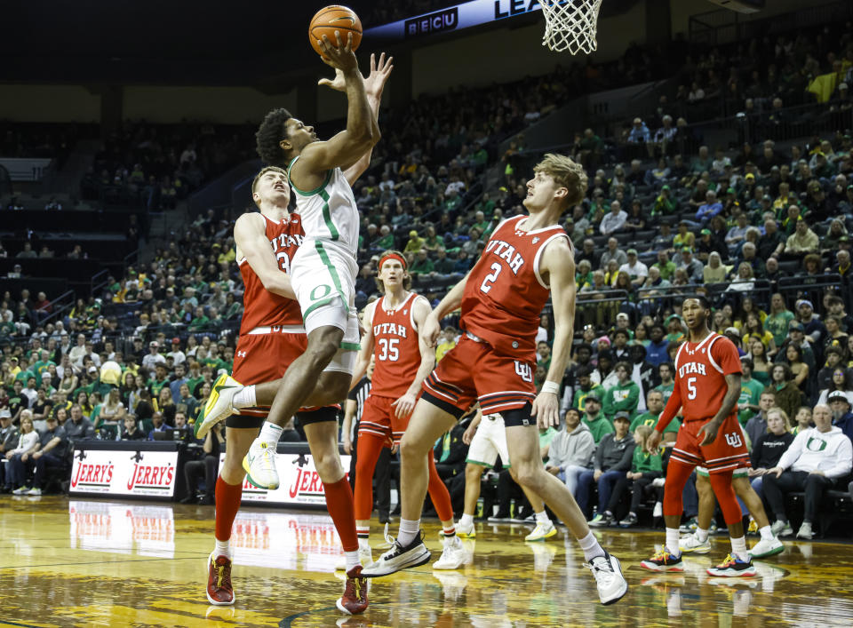 Oregon guard Kario Oquendo (0) shoot against Utah guard Cole Bajema (2) during the first half of an NCAA college basketball game in Eugene, Ore., Saturday, March 9, 2024. (AP Photo/Thomas Boyd)