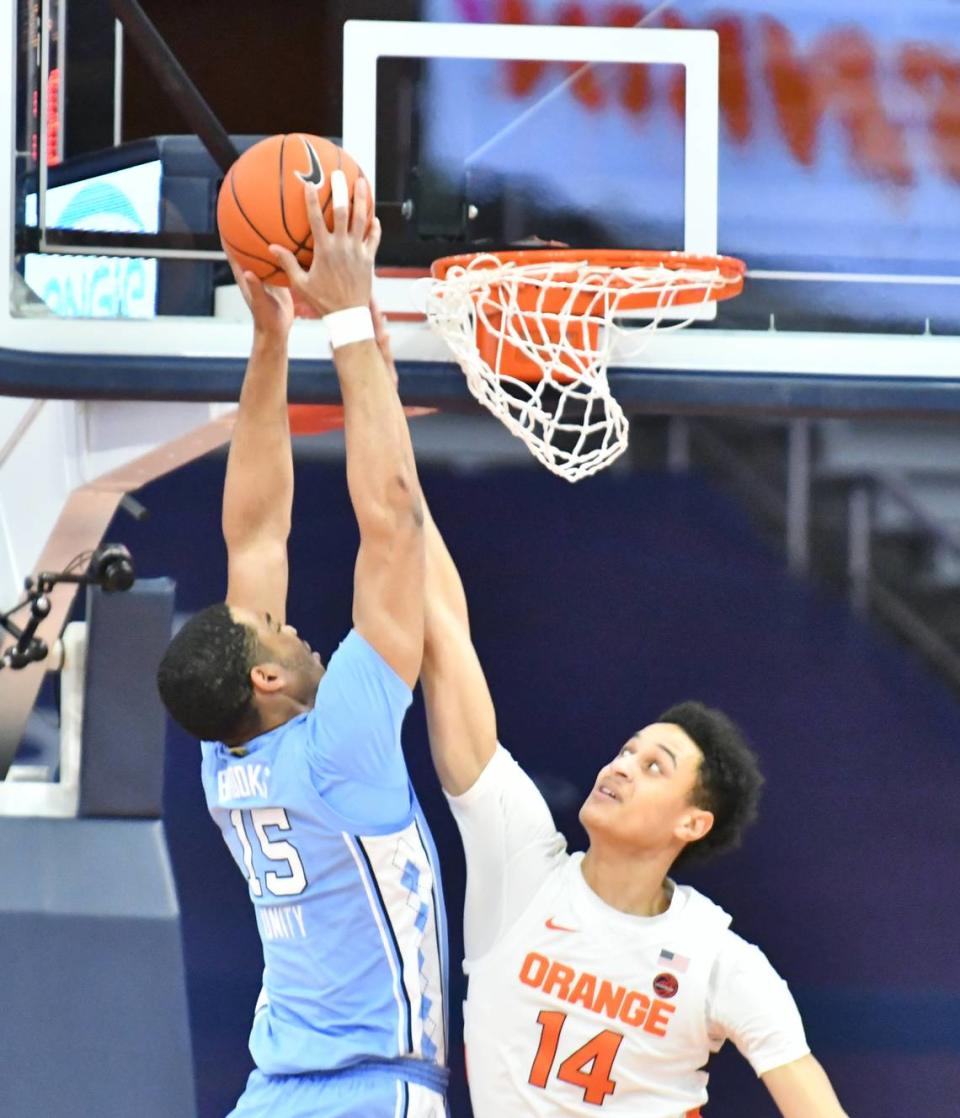 North Carolina Tar Heels forward Garrison Brooks (15) dunks the ball as Syracuse Orange center Jesse Edwards (14) attempts to block the shot in the first half at the Carrier Dome.