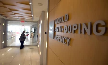 A woman walks into the head office for the World Anti-Doping Agency (WADA) in Montreal, November 9, 2015. REUTERS/Christinne Muschi