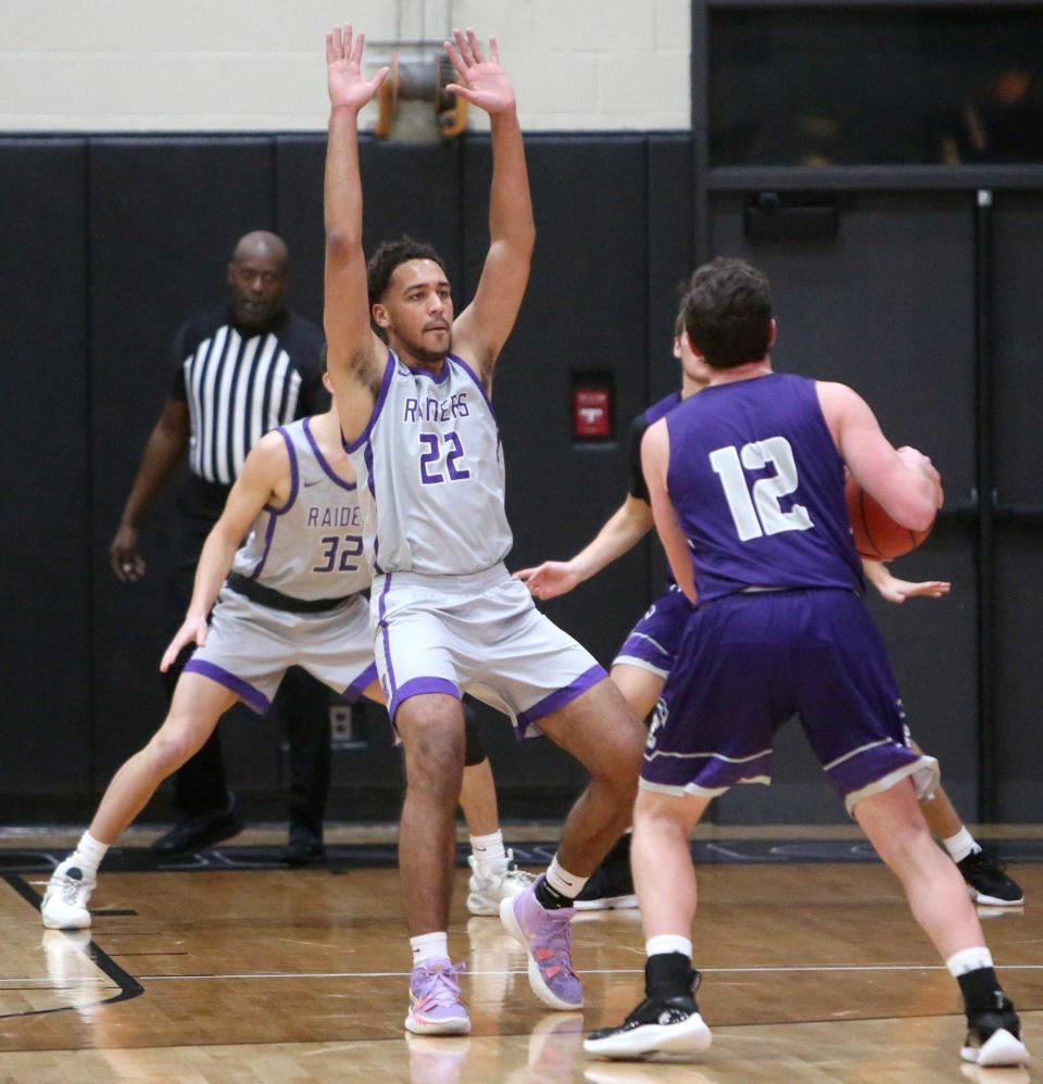 Mount Union's Christian Parker (22) guards Capital's Tyler Schreck (12) during a game on  Jan. 7.