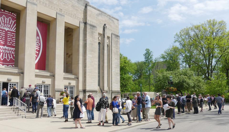 Hundreds of faculty wait to enter the IU Auditorium for the first all-faculty emergency meeting since 2005.