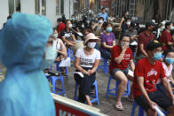 People wait in line for COVID-19 test in Hanoi, Vietnam, Friday, July 31, 2020. Vietnam reported on Friday the country's first ever death of a person with the coronavirus as it struggles with a renewed outbreak after 99 days without any cases. (AP Photo/Hau Dinh)