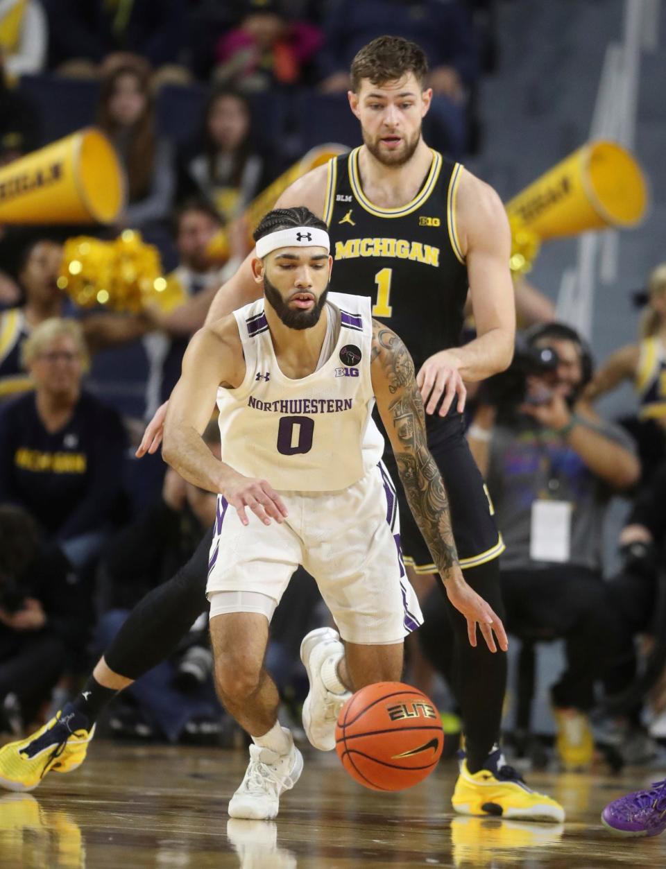 Michigan center Hunter Dickinson defends against Northwestern guard Boo Buie (0) during first half Jan. 15, 2023 at Crisler Center in Ann Arbor.