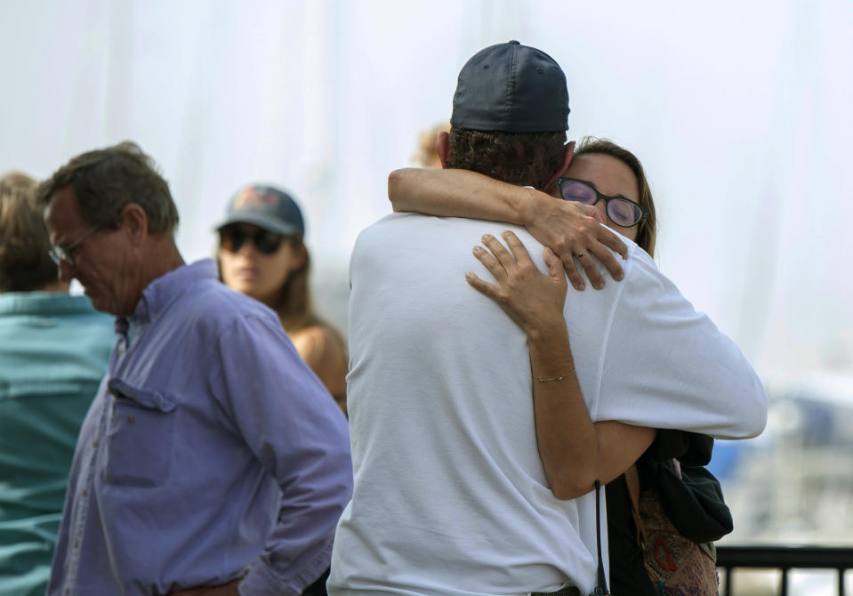 People hug each other as they await news outside of the Truth Aquatics office in Santa Barbara, Calif., on Monday, Sept. 2, 2019. Multiple people are feared dead after a dive boat caught fire before dawn Monday off the Southern California coast, according to the Coast Guard. (AP Photo/Christian Monterrosa)