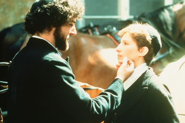 <p>Hulton Archive/Getty</p> Mandy Patinkin and Barbra Streisand in Yentl in 1983.
