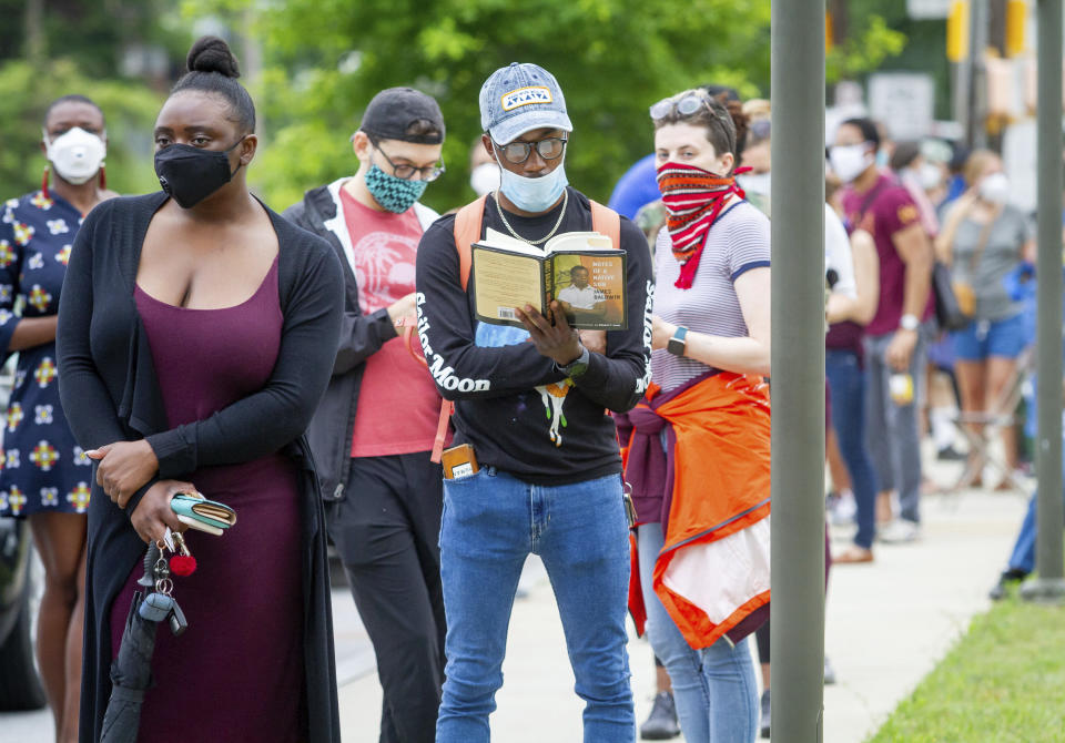 Voters wait in a line that stretched around the Metropolitan Library in Atlanta, Georgia, Tuesday, June 9, 2020. (Steve Schaefer/Atlanta Journal-Constitution via AP)