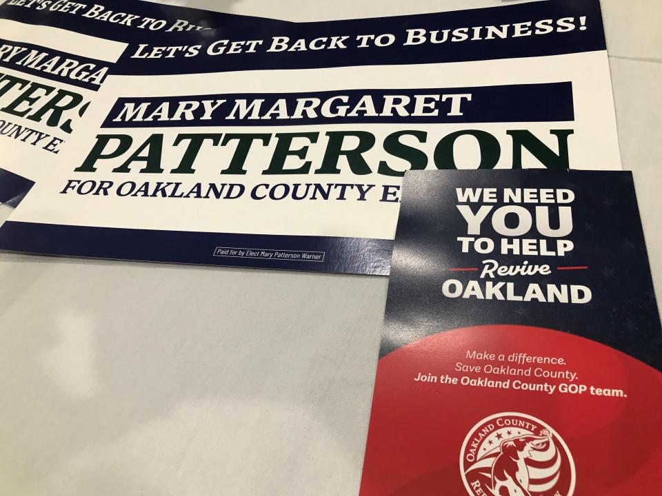 Campaign placards piled on a table at Deer Lake Athletic Club in Clarkston on July 26, 2023 show support for the new campaign of the daughter of the late L. Brooks Patterson.