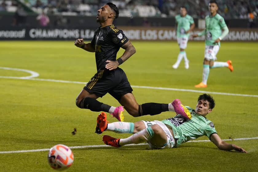 Denis Bouanga of the US'  Los Angeles FC, left, is tackled by Alfonso Alvarado of Mexico's Leon during the first leg of the CONCACAF championship final soccer match at Leon stadium in Guanajuato, Mexico, Wednesday, May 31, 2023. (AP Photo to/Eduardo Verdugo)