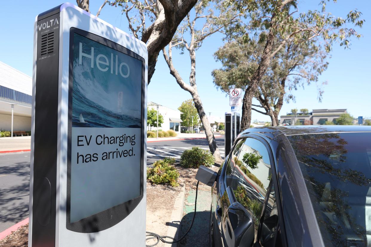 A BMW electric vehicle sits parked at a Volta EV charging station on July 28, 2023, in Corte Madera, California. Seven major automakers announced plans earlier this week to increase the number of high-powered electric vehicle chargers in the country with 30,000 new charging stations along highways and in urban areas. According to the Energy Department, there are currently an estimated 32,000 chargers across the country.