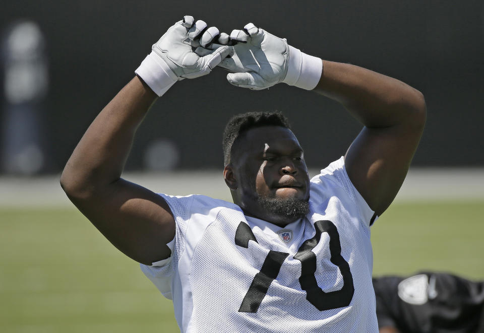 Oakland Raiders tackle Kelechi Osemele stretches during their football minicamp Tuesday, June 14, 2016, in Alameda, Calif. (AP Photo/Eric Risberg)