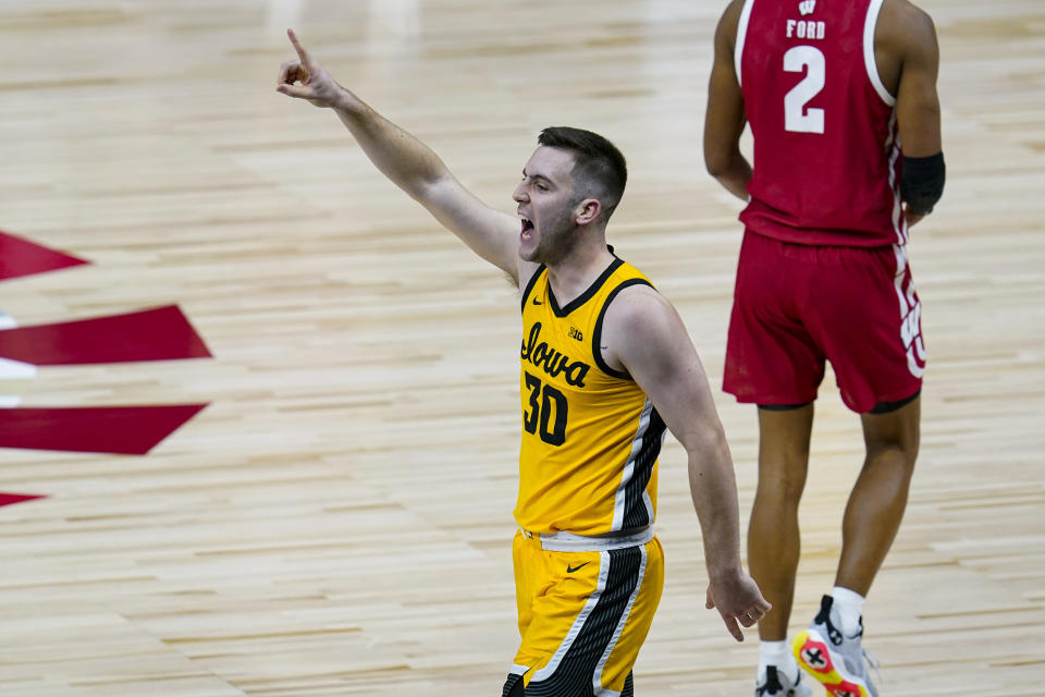 Iowa guard Connor McCaffery (30) celebrates in the closing minute against Wisconsin in an NCAA college basketball game at the Big Ten Conference men's tournament in Indianapolis, Friday, March 12, 2021. Iowa won 62-57. (AP Photo/Michael Conroy)