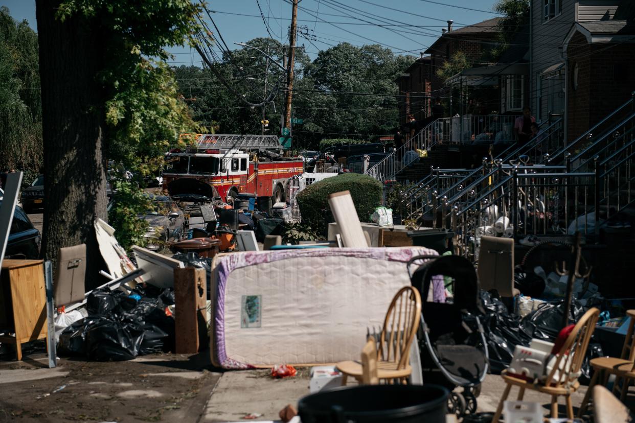 Residents sort through damaged and destroyed items after a night of heavy rain and wind caused many homes to flood on Sept. 2, 2021 in the Flushing neighborhood of the Queens borough of New York City.