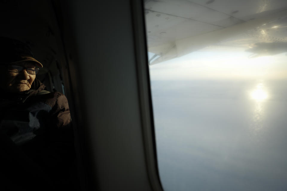 Joe Asuluk flies over his hometown Saturday, Jan. 18, 2020, near Toksook Bay, Alaska. The first Americans to be counted in the 2020 Census starting Tuesday, Jan. 21, live in this Bering Sea coastal village. The Census traditionally begins earlier in Alaska than the rest of the nation because frozen ground allows easier access for Census workers, and rural Alaska will scatter with the spring thaw to traditional hunting and fishing grounds. (AP Photo/Gregory Bull)