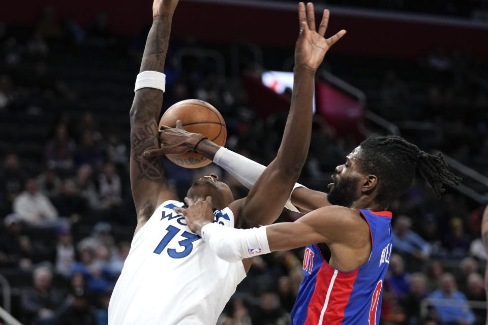 Detroit Pistons' Nerlens Noel (9) fouls Minnesota Timberwolves forward Nathan Knight (13) in the second half of an NBA basketball game in Detroit, Wednesday, Jan. 11, 2023. (AP Photo/Paul Sancya)