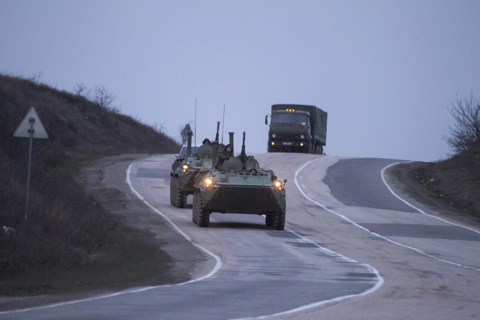 Russian military armoured personnel carriers (APC) drive on the road from Sevastopol to Simferopol