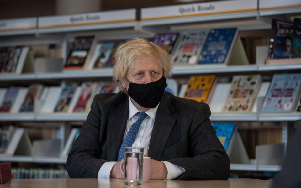 Prime Minister Boris Johnson meets with teachers in the library during a visit to Sedgehill School in Lewisham - PA