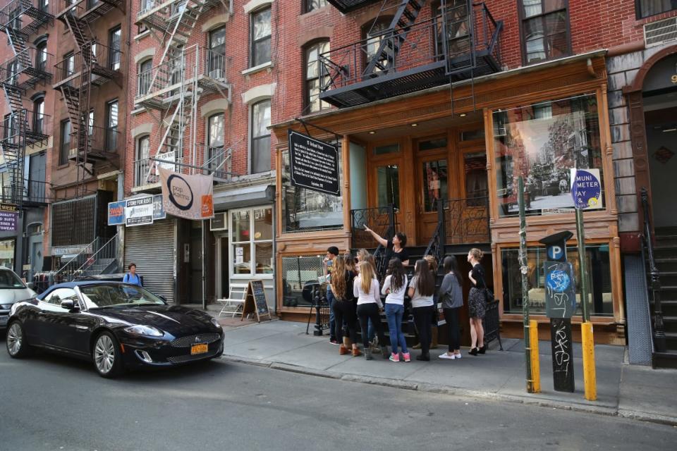 <div class="inline-image__title">166179430</div> <div class="inline-image__caption"><p>A tour group gathers outsides the Lower East Side’s Tenement Museum.</p></div> <div class="inline-image__credit">John Moore/Getty</div>