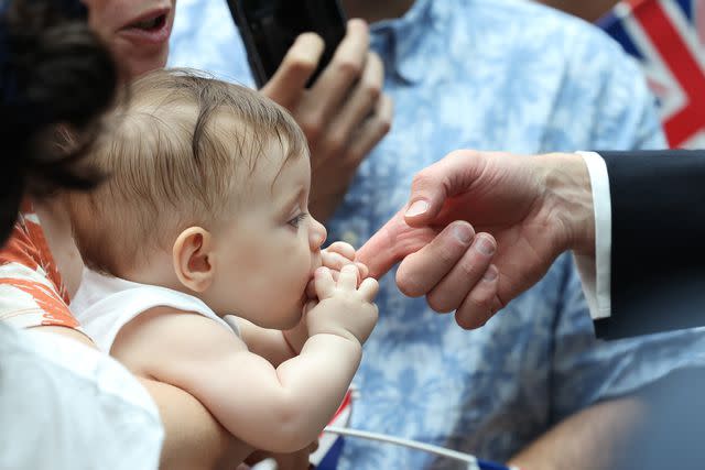 <p>Chris Jackson/Getty</p> Baby Albane Costa bites Prince William's finger at Changi Airport on November 5.