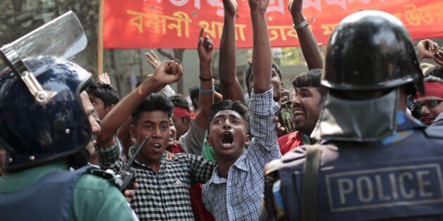 Supporters of National Transport Workers League, a wing of the ruling Awami League party shout slogans in front of the office of opposition Bangladesh Nationalist Party (BNP) during a demonstration against the ongoing nationwide blockade and strike called by the opposition in Dhaka, Bangladesh, Monday, Feb. 9, 2015. At least 63 people have lost their lives due to violence in the nationwide transportation blockade that began Jan.6, to pressure Prime Minister Sheikh Hasina to resign and announce new elections. (AP Photo/ A.M. Ahad) (Photo: )