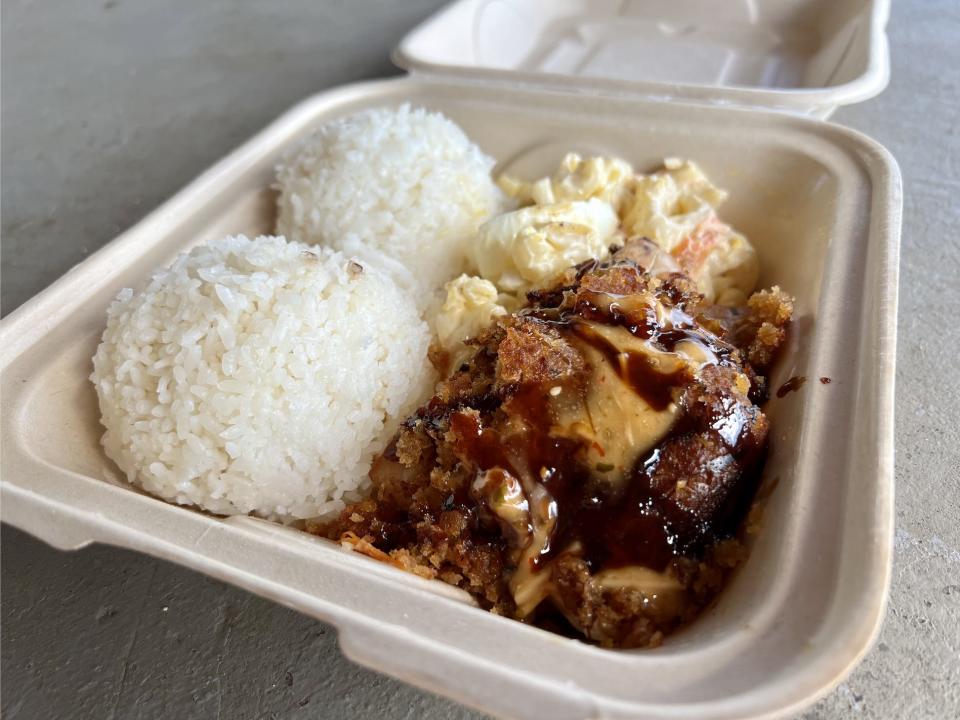 rice and panko-crusted fish in white paper takeout container