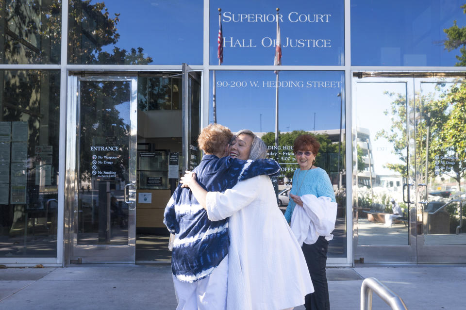 Violet Klaas, center, hugs supporters of Polly Klaas, outside Santa Clara County Superior Court in San Jose, Calif., Friday, May 31, 2024. A California judge will consider Friday whether to recall the death sentence against Richard Allen Davis, who in 1993 killed 12-year-old Polly Klaas after kidnapping her from her bedroom at knifepoint in a crime that shocked the nation.(AP Photo/Nic Coury)