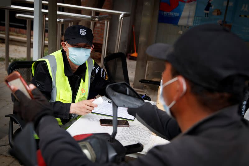 Delivery driver presents the status of his health app in Beijing