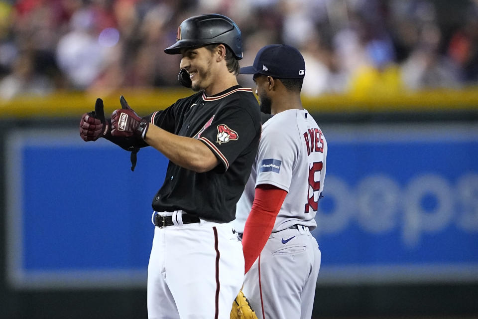 Arizona Diamondbacks right fielder Jake McCarthy gives the thumbs up to his dugout after hitting a double against the Boston Red Sox during the fifth inning of a baseball game, Saturday, May 27, 2023, in Phoenix. (AP Photo/Matt York)