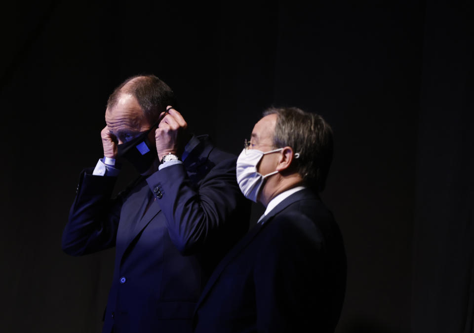 Candidate as leader of the Christian Democratic Union (CDU) Friedrich Merz, left, and North Rhine-Westphalia's Governor and candidate as leader of the Christian Democratic Union (CDU) Armin Laschet, right, stand behind the stage while the third candidate holds his speech on the second day of the party's 33rd congress held online because of the coronavirus pandemic, in Berlin on January 16, 2021. German Chancellor Angela Merkel’s party is choosing a new leader on Saturday, eight months before voters decide who will succeed Merkel in a national election. (Odd Andersen/Pool via AP)