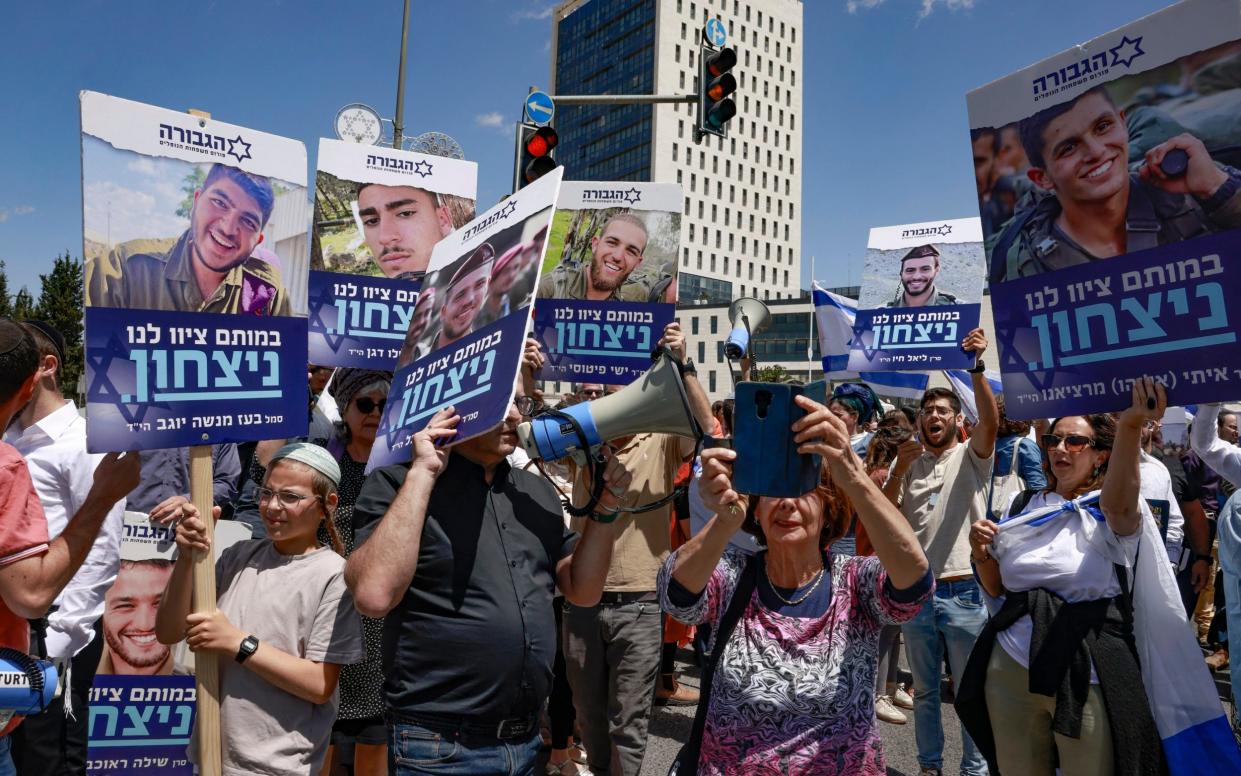 Relatives of soldiers killed in the conflict demonstrate near the prime minister's office in Jerusalem