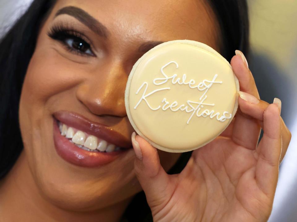 Gianna Pina runs Sweet Kreations out of her Brockton home. She holds up one of her creations, on Friday, July 1, 2022.