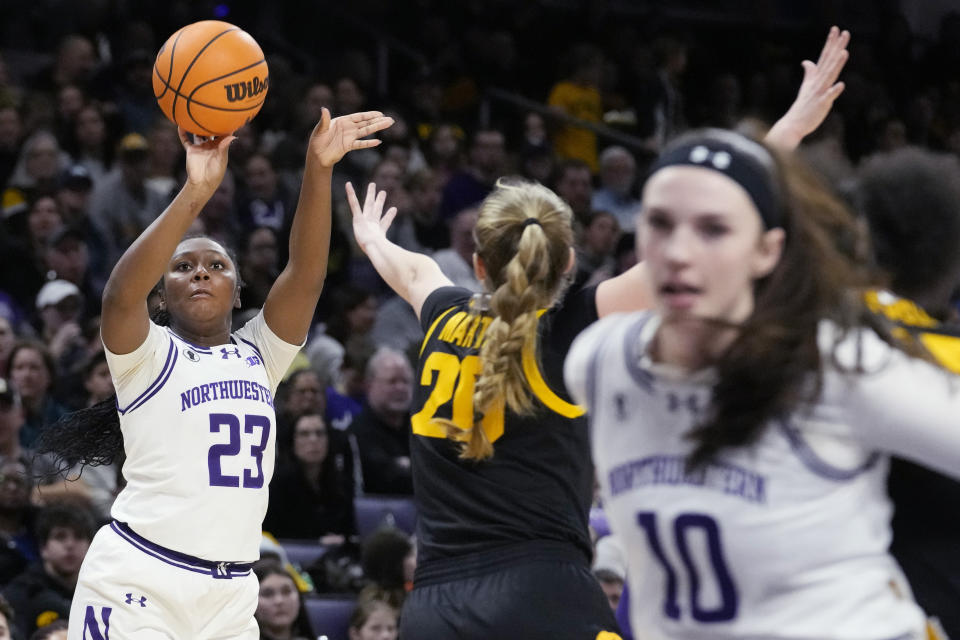 Northwestern guard Jasmine McWilliams, left, shoots against Iowa guard Kate Martin during the second half of an NCAA college basketball game in Evanston, Ill., Wednesday, Jan. 31, 2024. Iowa won 110-74. (AP Photo/Nam Y. Huh)