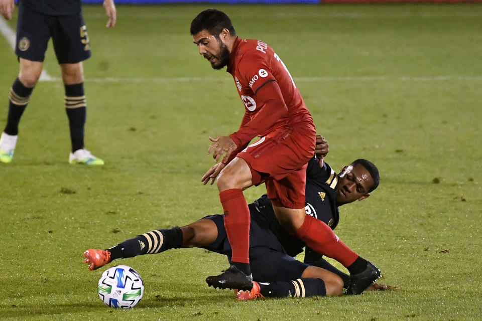 Toronto FC's Alejandro Pozuelo, top, pressures Philadelphia Union's Jose "El Brujo" Martinez during the first half of an MLS soccer match, Saturday, Oct. 3, 2020, in East Hartford, Conn. (AP Photo/Jessica Hill)