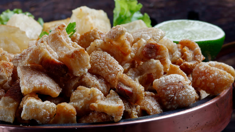 pork scratching served with lime