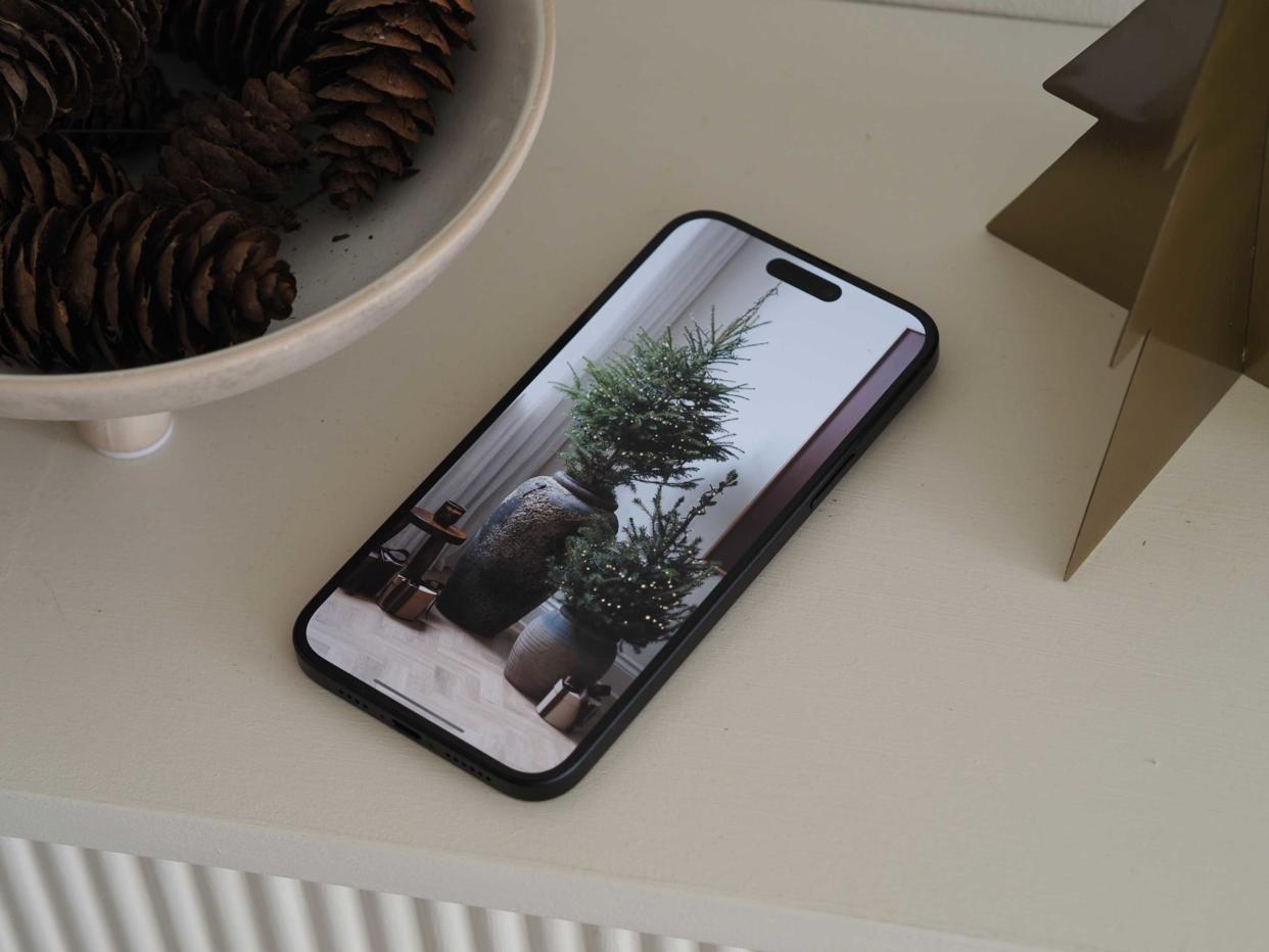  An iphone with a christmas tree on screen. 
