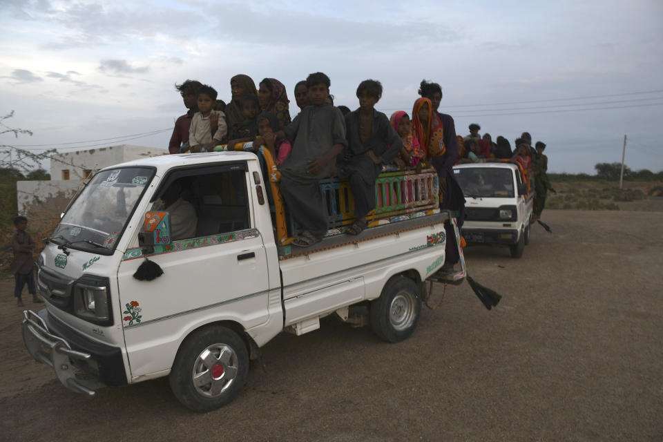 Local residents travel in vehicles as they evacuate the area due to Cyclone Biparjoy approaching, at a costal area Golarchi in Badin district, in Pakistan's Sindh province, Tuesday, June 13, 2023. Pakistan's army and civil authorities are planning to evacuate 80,000 people to safety along the country's southern coast, and thousands in neighboring India sought shelter ahead of Cyclone Biparjoy, officials said. (AP Photo/Umair Rajput)