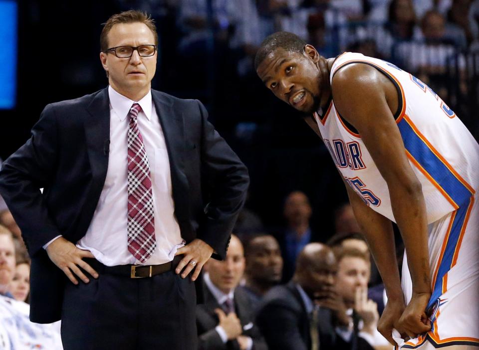 FILE - In this May 31, 2014, file photo, Oklahoma City Thunder coach Scott Brooks, left, and forward Kevin Durant pause during a break against the San Antonio Spurs in the second half of Game 6 of the Western Conference finals NBA basketball playoff series in Oklahoma City. The Thunder fired Brooks on Wednesday, April 22, 2015. (AP Photo/Sue Ogrocki, File)