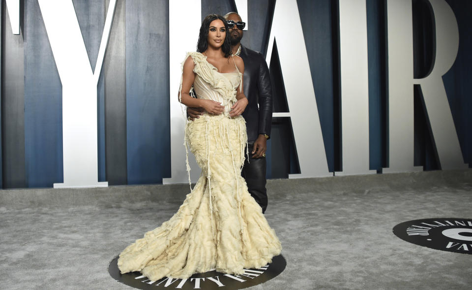 FILE - Kim Kardashian, left, and Kanye West arrive at the Vanity Fair Oscar Party on Feb. 9, 2020, in Beverly Hills, Calif. Kim Kardashian West filed for divorce Friday, Feb. 19, 2021, from Kanye West after 6 1/2 years of marriage. Sources familiar with the filing but not authorized to speak publicly confirmed that Kardashian filed for divorce in Los Angeles Superior Court. The filing was not immediately available. (Photo by Evan Agostini/Invision/AP, File)