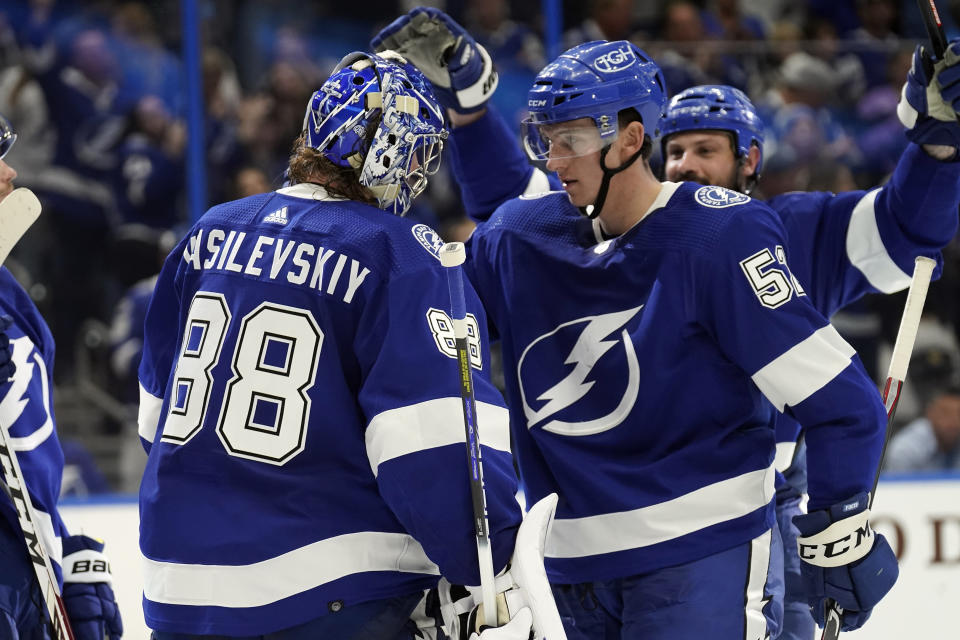 Tampa Bay Lightning goaltender Andrei Vasilevskiy (88) celebrates with defenseman Cal Foote (52) after an NHL hockey game against the Seattle Kraken Friday, Nov. 26, 2021, in Tampa, Fla. (AP Photo/Chris O'Meara)