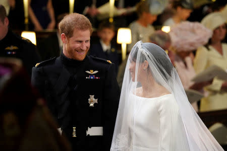 Prince Harry looks at his bride, Meghan Markle, as she arrives accompanied by the Prince of Wales in St George's Chapel at Windsor Castle for their wedding in Windsor, Britain, May 19, 2018. Jonathan Brady/Pool via REUTERS