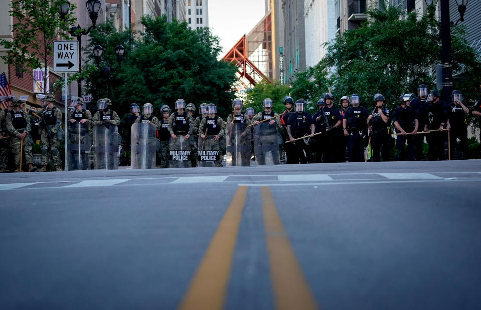 Image: National Guard soldiers stand with Louisville Metro Police to block a street during protests on May 31, 2020. (Bryan Woolston / Reuters file)