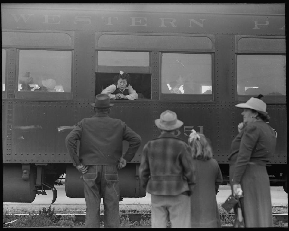 Japanese Americans being removed through the Wartime Relocation Authority