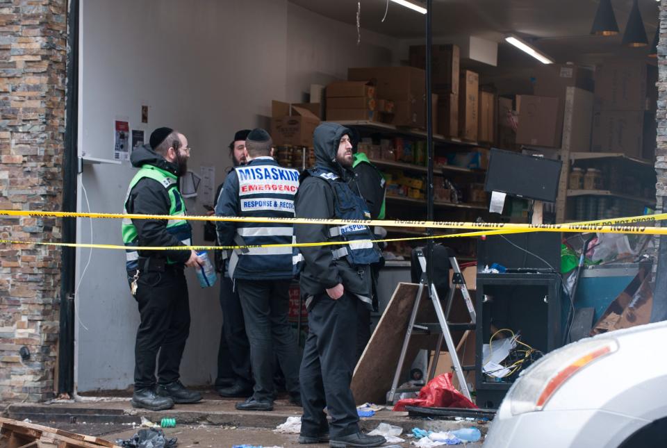 Emergency personnel and investigators work at the scene the day after an hours-long gun battle with two men around a kosher market in Jersey City, New Jersey, U.S., December 11, 2019. REUTERS/Lloyd Mitchell (Photo: Lloyd Mitchell / Reuters)